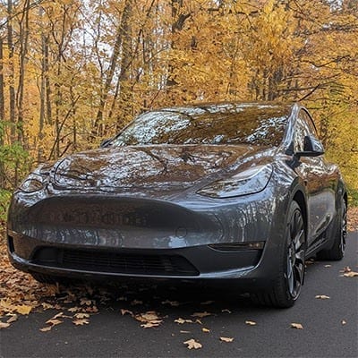 Tesla in autumn leaves — new car paint protection
